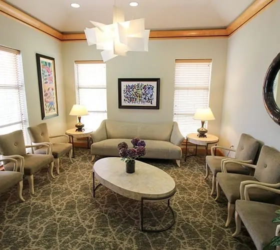 The waiting area at Grand Dental Studio, with armchairs around a low table.