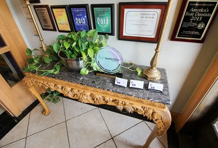 A console table with plaques and awards in the office.