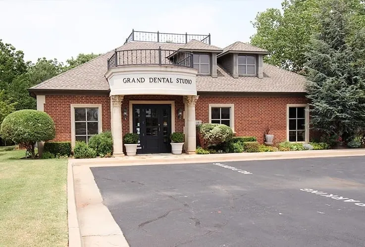 Grand Dental Studio, a brick building with a white portico, on NW Grand Boulevard.